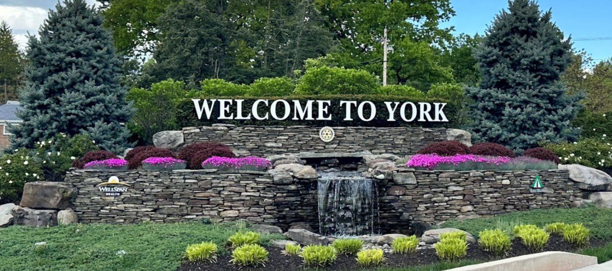 Welcome to York sign and waterfall