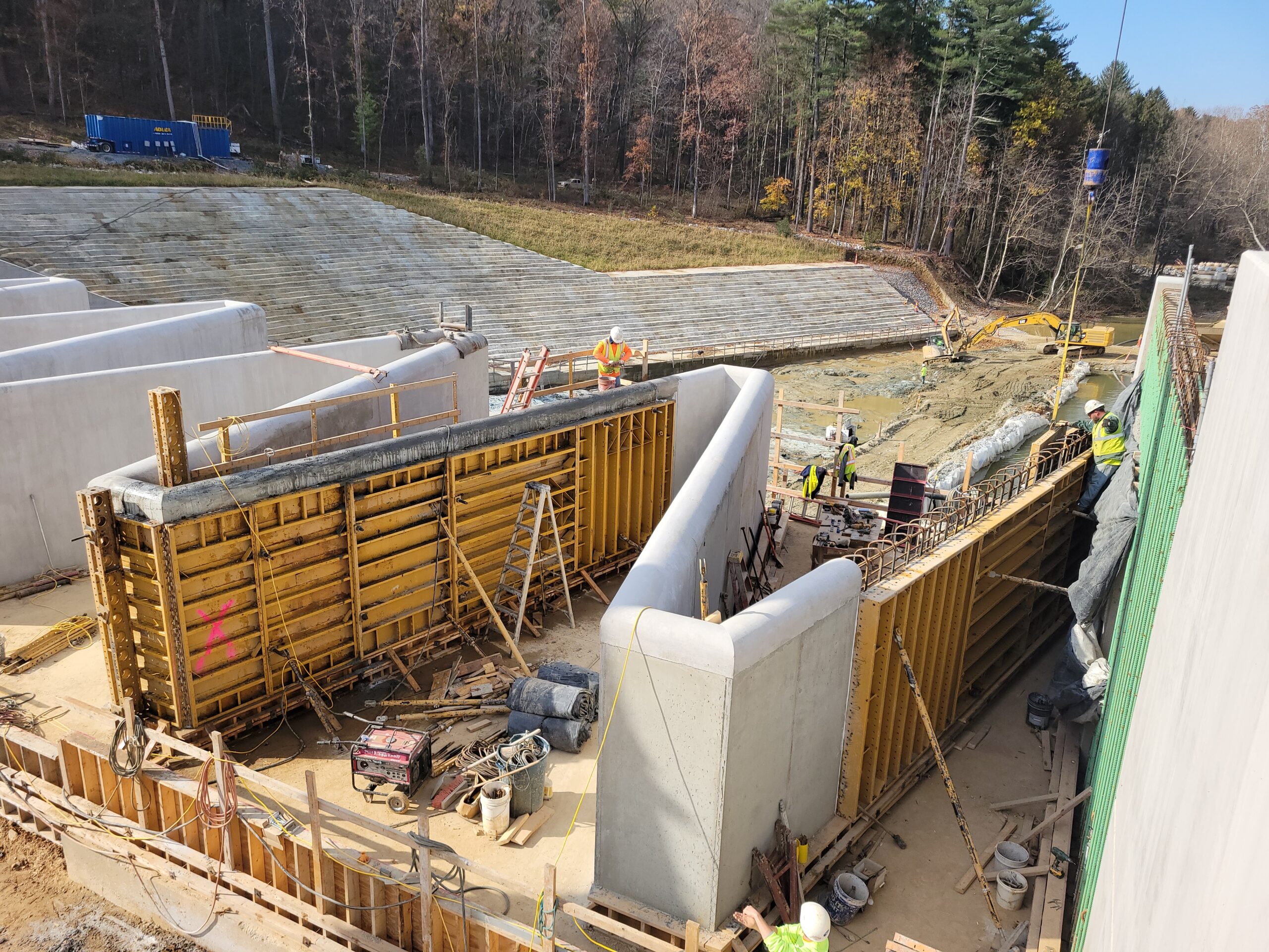 Construction workers building the Lake Williams Dam labyrinth cycle wall.