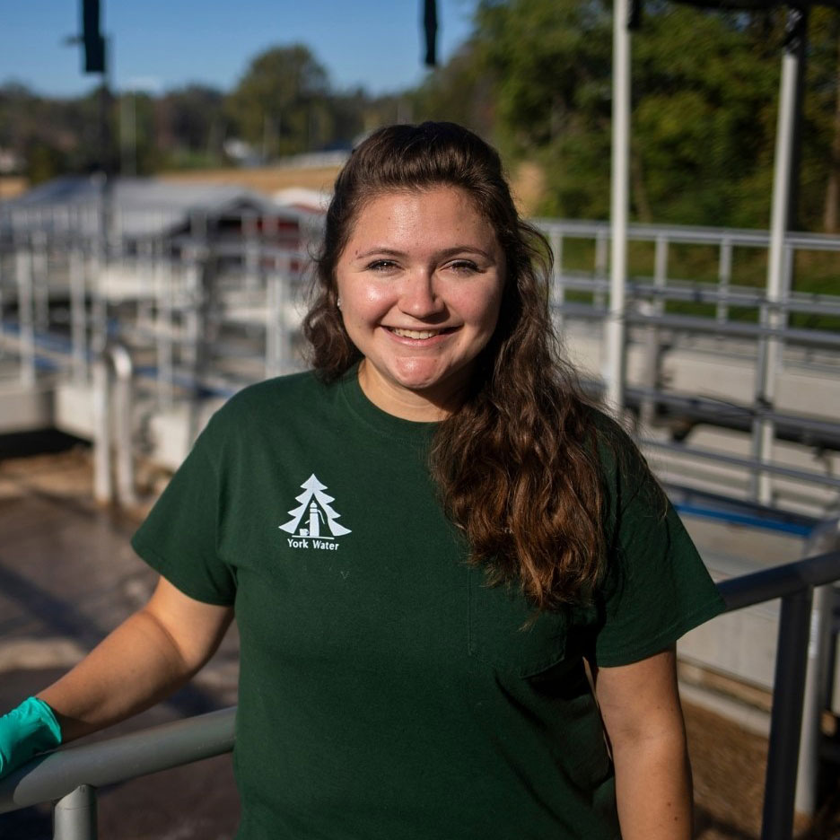 Staff member smiling in the sunshine.