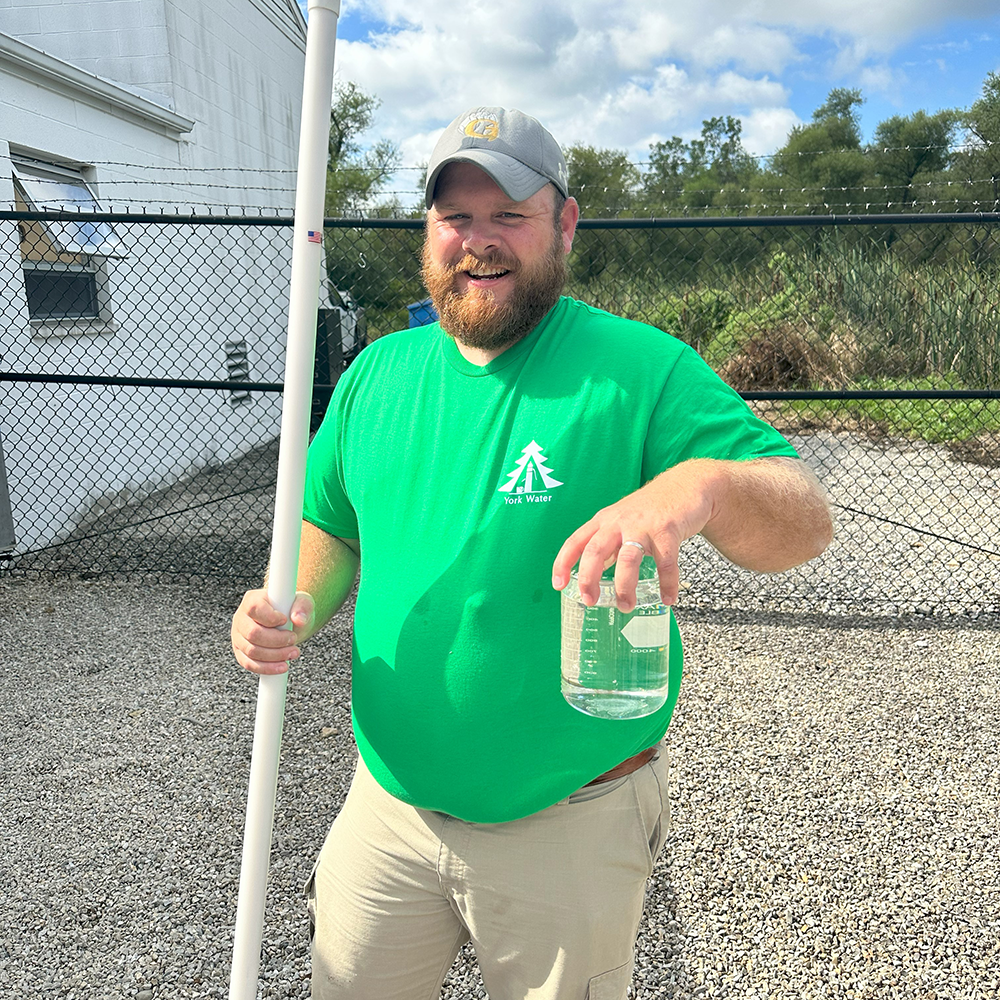 A York Water employee holds up a clean water sample