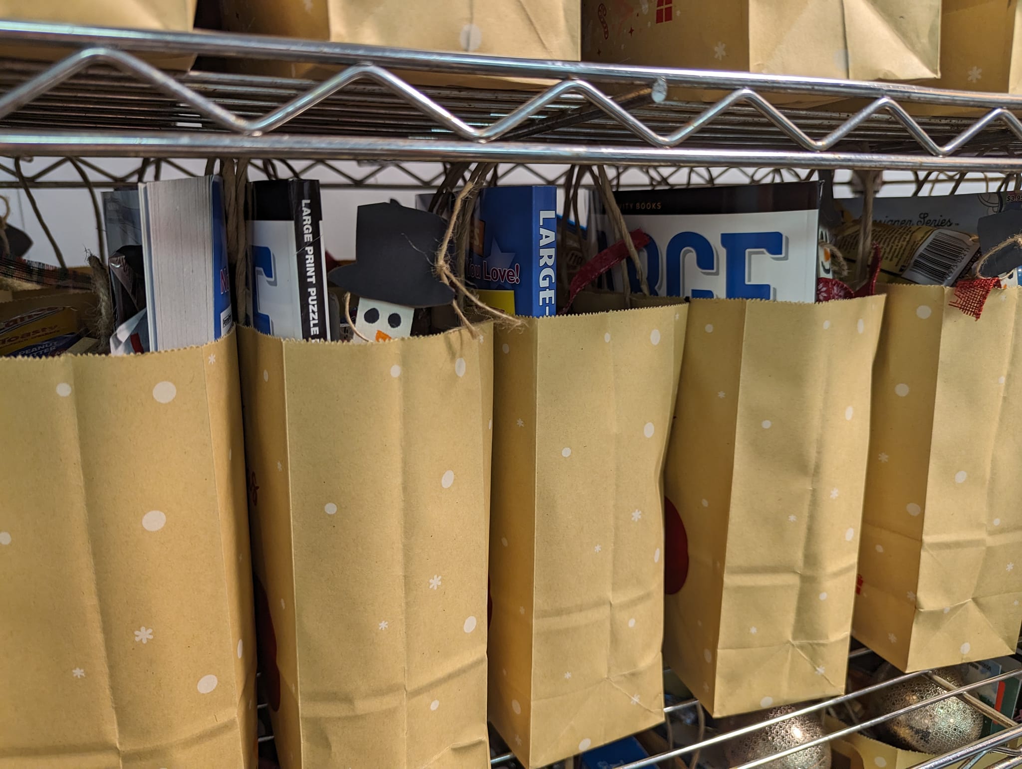 Brown bags are filled with donations for Cheer Bags for seniors.