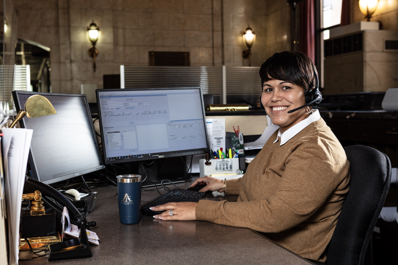 York Water Customer Service staff member sitting at her desk in front of her computer with headphones on.