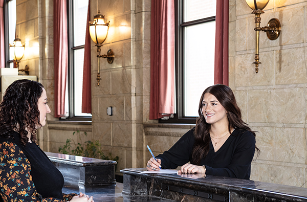 A York Water employee speaks with a customer across the counter in York Water Company's lobby.