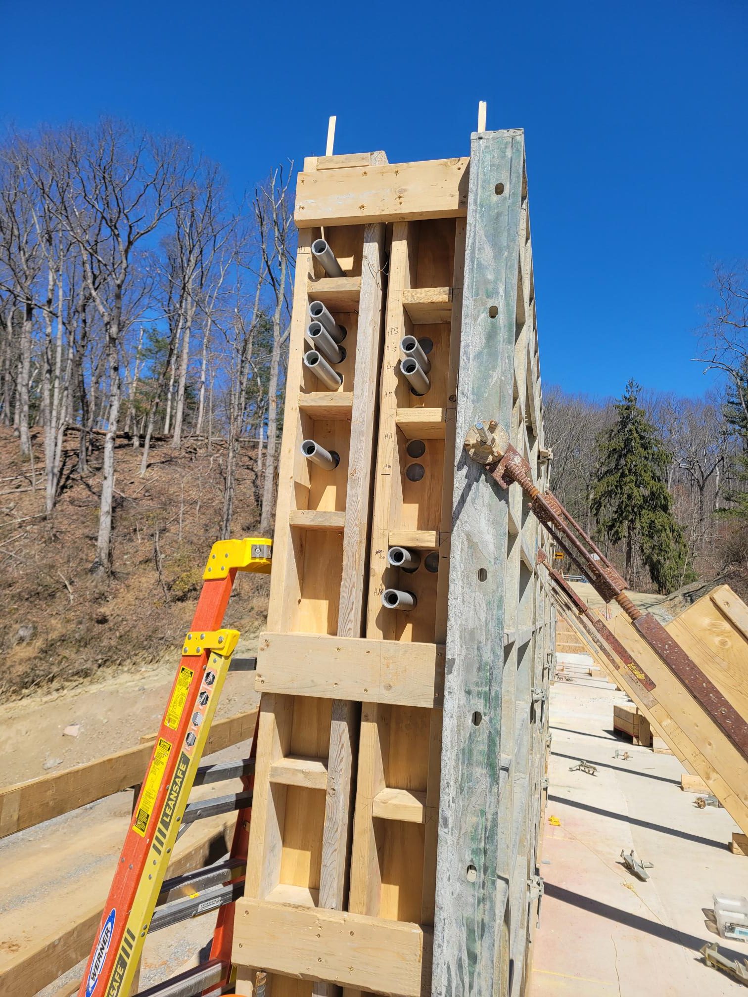 Electrical conduits being installed in the concrete wall.