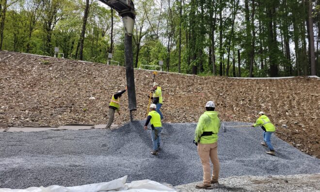 Construction workers pouring cement at the Lake Williams Dam.