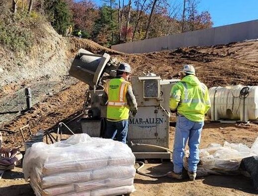 Construction workers at the Lake Williams Dam mixing concrete.