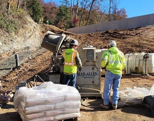 Construction workers at the Lake Williams Dam mixing concrete.