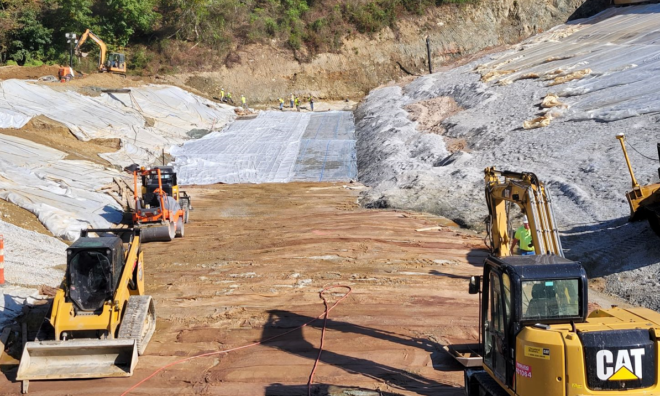 Heavy machinery working on the dam.